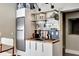 Contemporary mini-kitchen with sleek cabinetry, shelving, stainless steel fridge and hardwood countertops at 4707 Troydale Rd, Tampa, FL 33615