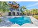 Inviting backyard pool with a spiral staircase, lounge chairs, and lush tropical landscaping at 4707 Troydale Rd, Tampa, FL 33615