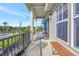 Inviting covered porch with ample seating and view of the yard and surrounding greenery at 4707 Troydale Rd, Tampa, FL 33615