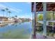 Picturesque waterfront view featuring a private boat dock, boat lift, and tranquil canal at 4707 Troydale Rd, Tampa, FL 33615