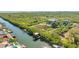 A picturesque waterfront view showcases a tranquil canal, surrounded by lush vegetation and luxurious homes at 4707 Troydale Rd, Tampa, FL 33615