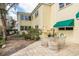 Outdoor patio area with a glass table and wicker seating at 515 Bayview Ne Dr # 4, St Petersburg, FL 33704