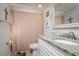 Bathroom featuring a shower curtain, single sink vanity with marble countertop, mirror, and toilet at 5315 Swallow Dr, New Port Richey, FL 34652