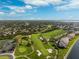 Scenic aerial view of a golf course community with lush greenery, waterways, and blue skies at 5950 Pelican Bay S Plz # Ph-2F, Gulfport, FL 33707