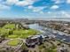 Scenic aerial view of golf course, yacht club, harbor with boat slips, waterfront homes, and a view of the bay at 5950 Pelican Bay S Plz # Ph-2F, Gulfport, FL 33707