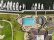 Aerial view of pool, marina, golf course with lush green lawns at 5950 Pelican Bay S Plz # Ph-2F, Gulfport, FL 33707