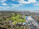 Aerial view of the golf course, community clubhouse, pool, and marina at 5950 Pelican Bay S Plz # Ph-2F, Gulfport, FL 33707