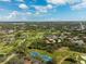 Stunning aerial view of a neighborhood with lush greenery, waterways, golf course, and tennis courts at 5950 Pelican Bay S Plz # Ph-2F, Gulfport, FL 33707
