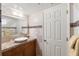 Well-lit bathroom with a vessel sink, granite countertop, decorative backsplash, and a neutral-colored tile scheme at 5950 Pelican Bay S Plz # Ph-2F, Gulfport, FL 33707