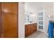Bathroom featuring wood cabinets with drawers and door, a large mirror and plenty of lighting at 5950 Pelican Bay S Plz # Ph-2F, Gulfport, FL 33707