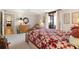 Well-lit bedroom with a cozy quilt bed, carpeted floors, and plenty of space for other furniture at 5950 Pelican Bay S Plz # Ph-2F, Gulfport, FL 33707