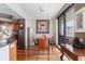 Bright dining area featuring wood floors, modern lighting, and sliding glass doors to the outdoor balcony at 5950 Pelican Bay S Plz # Ph-2F, Gulfport, FL 33707