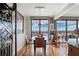 Dining room with seating for four, hardwood floors, and expansive windows with a city view at 5950 Pelican Bay S Plz # Ph-2F, Gulfport, FL 33707