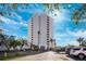 Modern condominium building with lush landscaping, ample parking, and a striking architectural design at 5950 Pelican Bay S Plz # Ph-2F, Gulfport, FL 33707