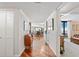 Hallway leading to the living area featuring hardwood floors, modern lighting, and an open floor plan at 5950 Pelican Bay S Plz # Ph-2F, Gulfport, FL 33707