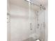 Modern walk-in shower featuring stylish wavy white tiles, sleek fixtures, and glass door at 5950 Pelican Bay S Plz # Ph-2F, Gulfport, FL 33707