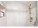 Modern walk-in shower with wavy white tiles, a built-in shelf, and sleek chrome fixtures at 5950 Pelican Bay S Plz # Ph-2F, Gulfport, FL 33707