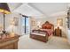 Bright bedroom featuring a balcony, beautiful wood furniture, and neutral carpeting for a cozy, inviting space at 5950 Pelican Bay S Plz # Ph-2F, Gulfport, FL 33707