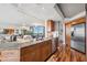 Open-concept kitchen with granite countertops, stainless steel appliances, and direct access to the living room at 5950 Pelican Bay S Plz # Ph-2F, Gulfport, FL 33707