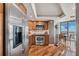Well-equipped kitchen featuring a stainless steel refrigerator and appliances, complemented by wood cabinets and flooring at 5950 Pelican Bay S Plz # Ph-2F, Gulfport, FL 33707