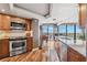 Well-equipped kitchen boasts wood cabinets, stainless steel appliances, and expansive windows with breathtaking water views at 5950 Pelican Bay S Plz # Ph-2F, Gulfport, FL 33707