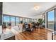 Bright living room featuring hardwood floors, floor-to-ceiling windows, a large balcony, and comfortable furniture at 5950 Pelican Bay S Plz # Ph-2F, Gulfport, FL 33707