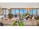 Bright living room showcasing floor-to-ceiling windows with a stunning view of the intercoastal waterway and comfortable seating at 5950 Pelican Bay S Plz # Ph-2F, Gulfport, FL 33707