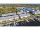 Aerial of the townhome community with private boat docks, lush landscaping and nearby wooded area at 6007 Anchorage Way, St Petersburg, FL 33712