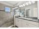 Luxury bathroom with a large shower, glass door, and double sink vanity at 6007 Anchorage Way, St Petersburg, FL 33712