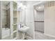 Bathroom with shower, tub and traditional-style pedestal sink with oval mirror at 6007 Anchorage Way, St Petersburg, FL 33712