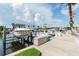 View of a boat docked at a private marina with clear skies and manicured landscaping at 6007 Anchorage Way, St Petersburg, FL 33712