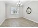 The dining room boasts tile floors, natural light, and a modern chandelier at 6007 Anchorage Way, St Petersburg, FL 33712