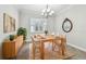 Bright dining room features natural light, modern decor, and a stylish chandelier at 6007 Anchorage Way, St Petersburg, FL 33712