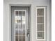 Close-up of the front door with sidelight, providing a bright and welcoming entry at 6007 Anchorage Way, St Petersburg, FL 33712