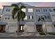 Charming townhomes featuring two-car garages, shingle siding, and well-maintained landscaping with beautiful palm trees at 6007 Anchorage Way, St Petersburg, FL 33712