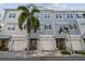 Charming townhomes featuring two-car garages, shingle siding, and well-maintained landscaping with beautiful palm trees at 6007 Anchorage Way, St Petersburg, FL 33712