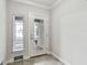 Well-lit foyer featuring tiled flooring, a glass-paneled front door, and a sidelight for a bright entry at 6007 Anchorage Way, St Petersburg, FL 33712