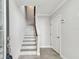 Bright foyer with staircase, tiled floors, and neutral walls creating a welcoming ambiance at 6007 Anchorage Way, St Petersburg, FL 33712
