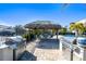 Poolside grilling area with stainless steel grills and a tiki hut nearby at 6007 Anchorage Way, St Petersburg, FL 33712