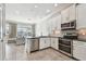 Bright kitchen flows into a living space, showcasing stainless appliances and contemporary design at 6007 Anchorage Way, St Petersburg, FL 33712