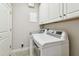 Bright laundry room with modern appliances and ample cabinet space at 6007 Anchorage Way, St Petersburg, FL 33712