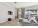 Cozy living room featuring tile floors, a modern sofa, and expansive windows with water views at 6007 Anchorage Way, St Petersburg, FL 33712
