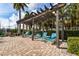 A pergola overlooks lounge chairs at the pool, offering a relaxing shaded area at 6007 Anchorage Way, St Petersburg, FL 33712