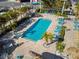 A high angle view of a rectangular pool with palm trees and ample lounge chairs at 6007 Anchorage Way, St Petersburg, FL 33712