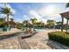 Beautiful community pool area featuring tiki huts, lounge chairs, and lush landscaping at 6007 Anchorage Way, St Petersburg, FL 33712