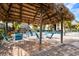 Tiki hut pool side seating with tables and chairs for entertaining at 6007 Anchorage Way, St Petersburg, FL 33712