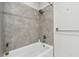 Bathroom featuring tiled shower with white bathtub at 6007 Anchorage Way, St Petersburg, FL 33712