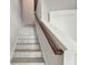 Bright staircase with tile steps and wood railing leading to the next level of the home at 6007 Anchorage Way, St Petersburg, FL 33712