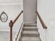 Carpeted staircase with a wooden handrail and white spindles at 6007 Anchorage Way, St Petersburg, FL 33712