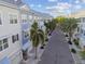 A neighborhood street view showcasing coastal townhomes with well-maintained landscaping and community charm at 6007 Anchorage Way, St Petersburg, FL 33712